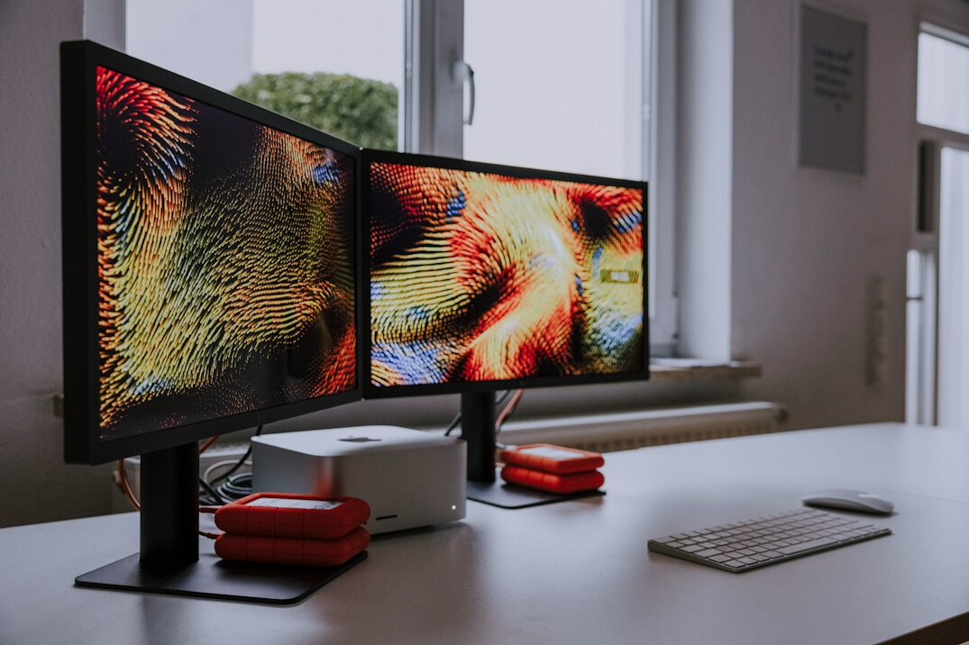 Laptop and workspace with code on the display