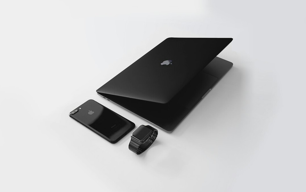 Laptop with code editor open on a wooden desk