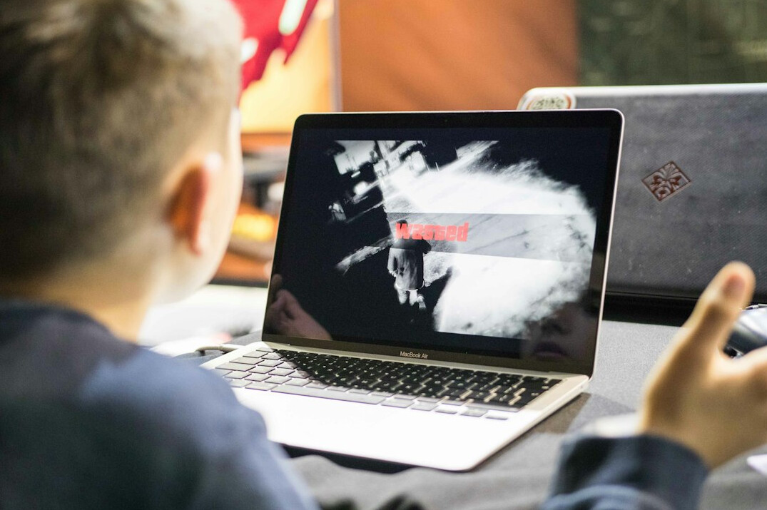student coding on laptop
