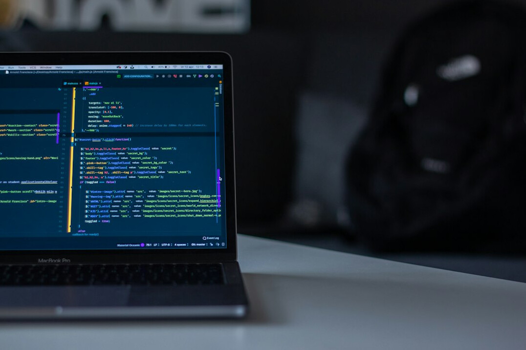 web developer coding on laptop