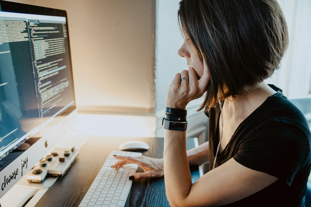 person coding at desk